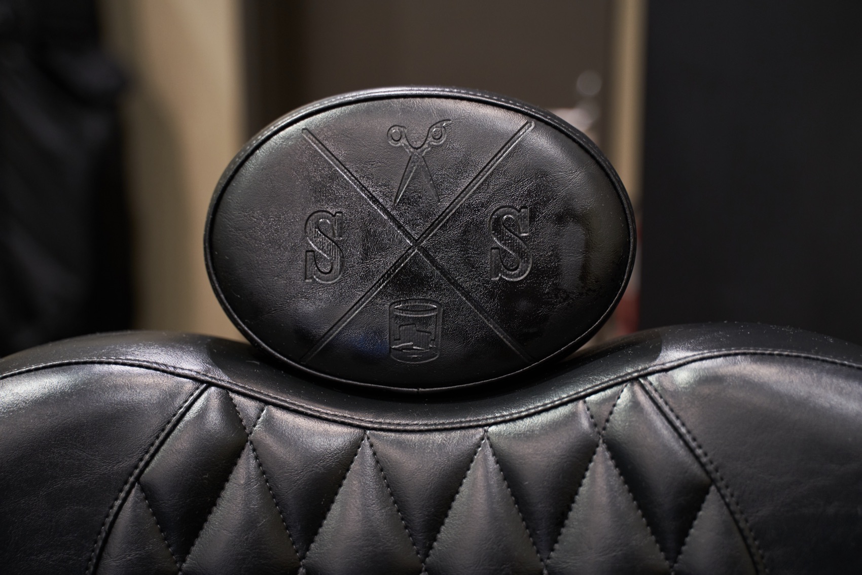 A Scissors & Scotch barber chair with the embossed S&S emblem
