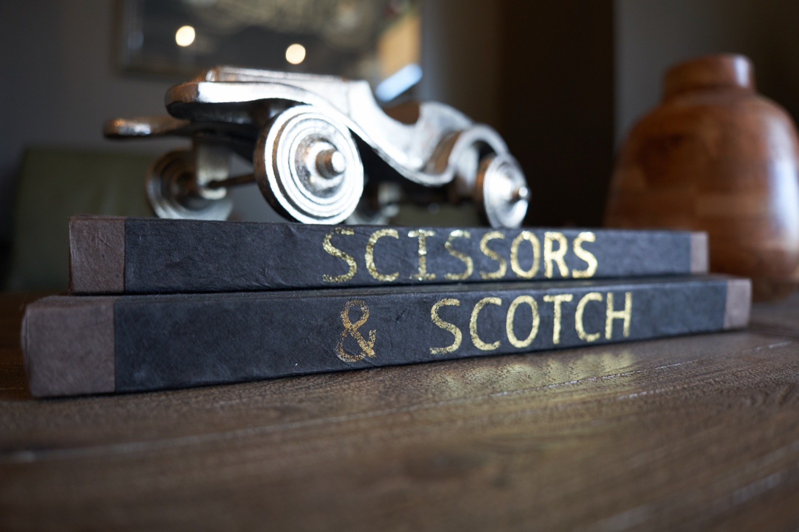 Gold-lettered Scissors & Scotch books in the lounge