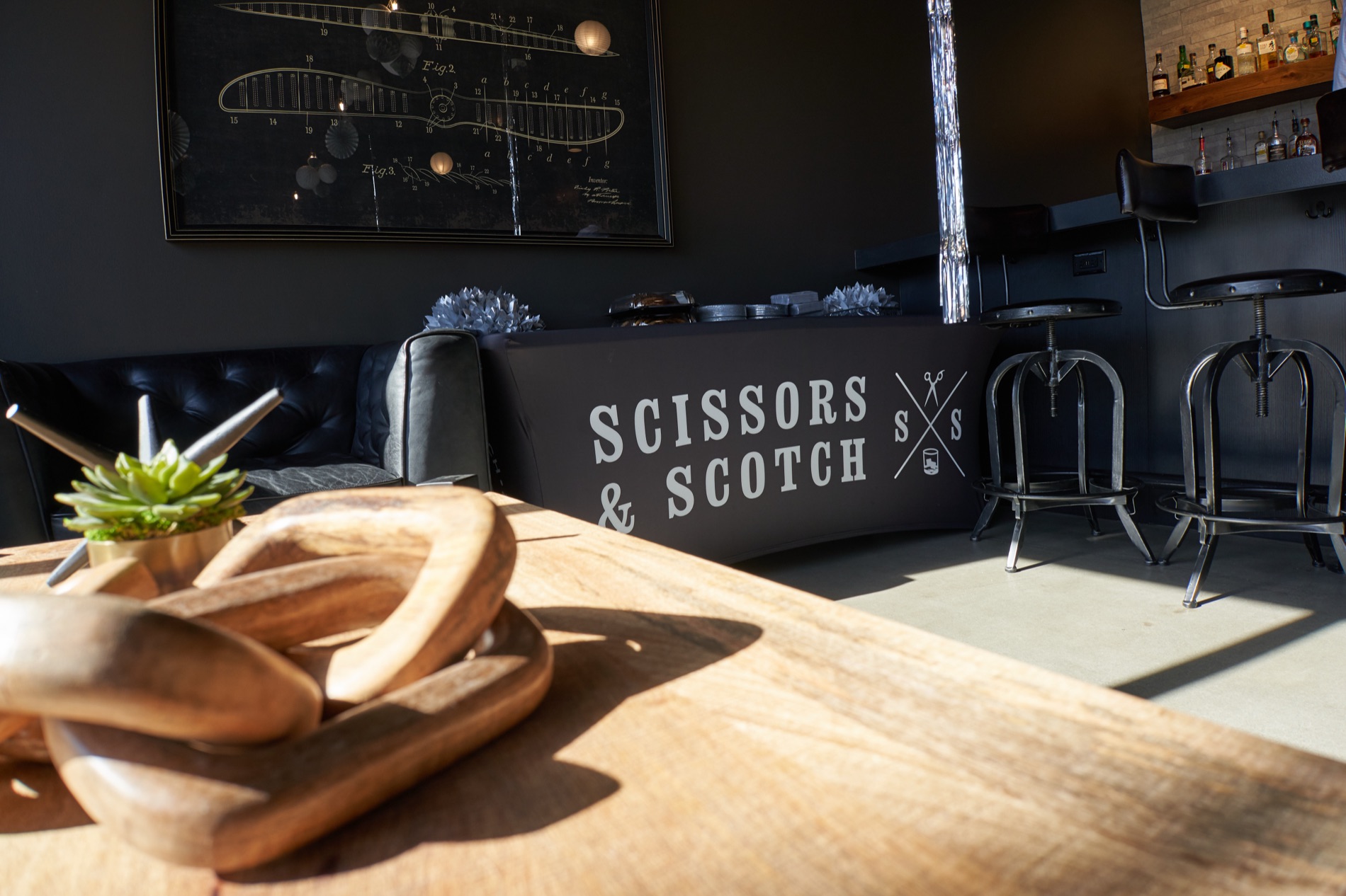 The branded lounge counter and bar inside Scissors & Scotch Uptown Charlotte