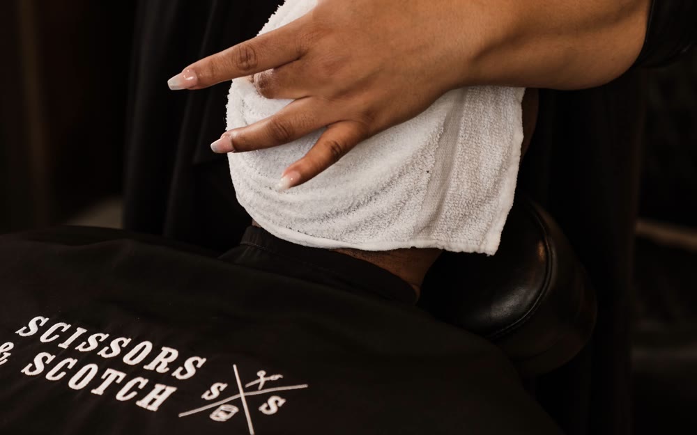 A hot-towel treatment at Scissors & Scotch Uptown Charlotte