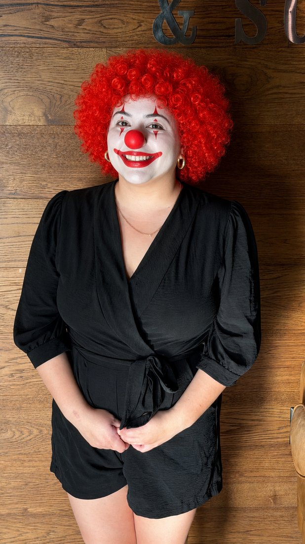 Maria in full clown costume, lounge and bar at Scissors & Scotch Uptown Charlotte